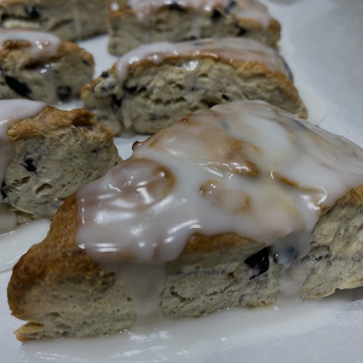 Close up on a tray lined with lemon blueberry scones